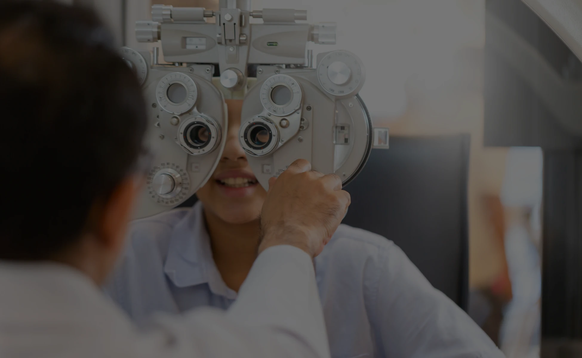 Boy at eye exam with eye doctor